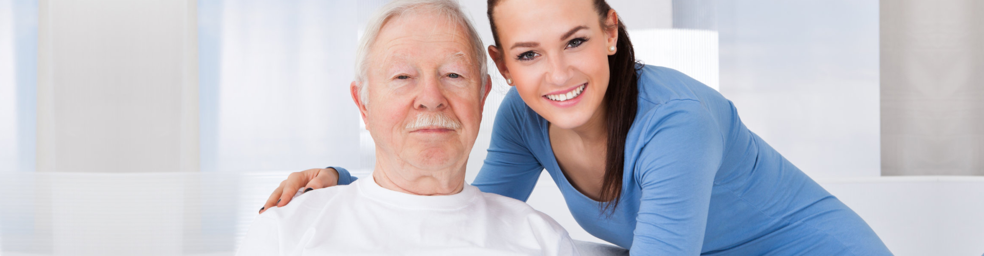 caregiver smiling with elderly man